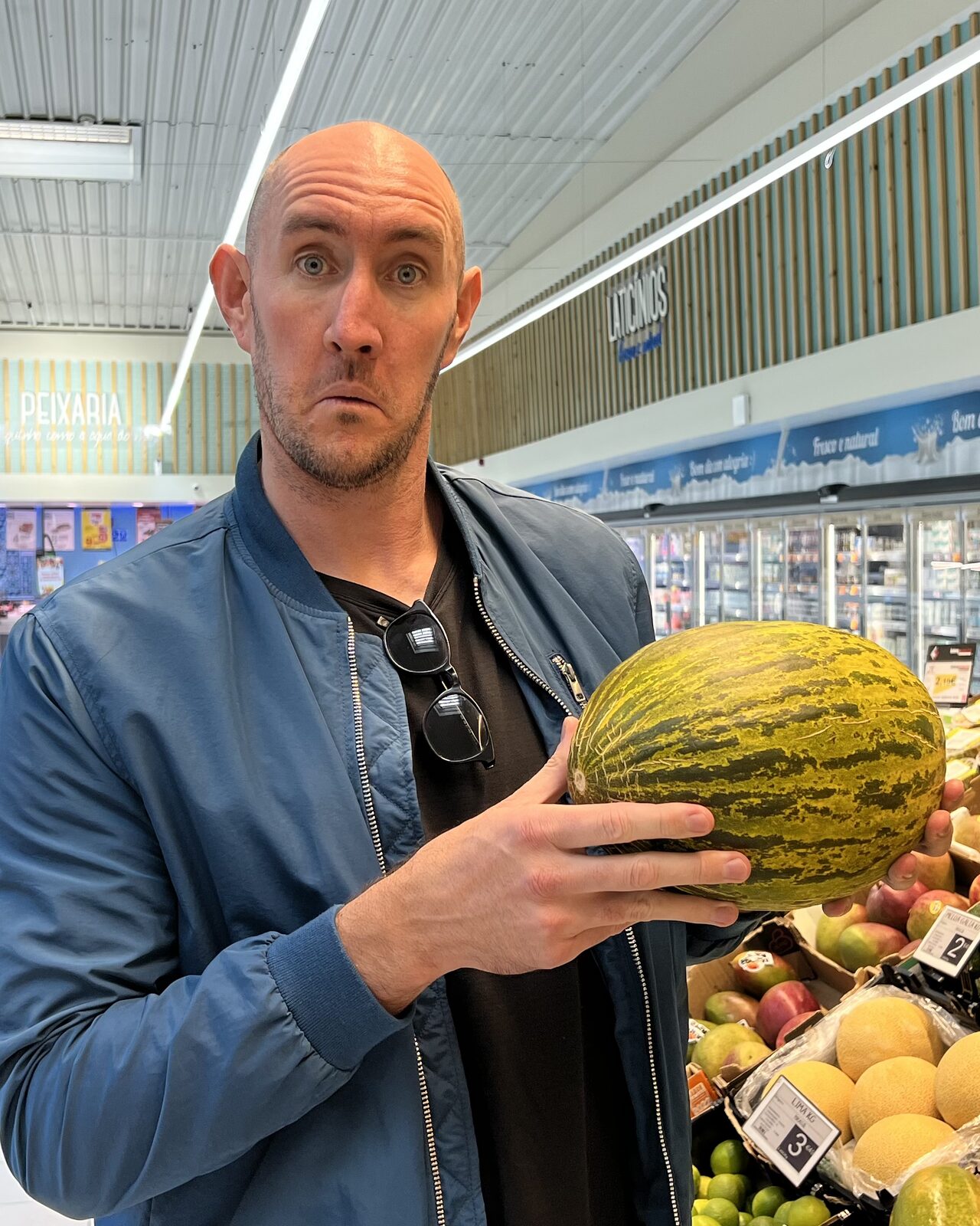 Jason Zook holding a Portuguese melon in a grocery store, 2026